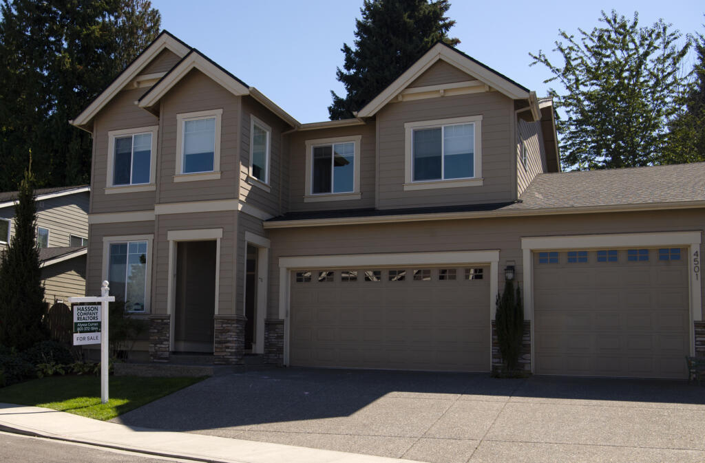 A house on Northeast 118th Street with a Hasson Company Realtors "For Sale" sign out front in September 2021, in north Vancouver.