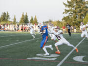 Ridgefield receiver Carter Ferber eludes a defender during a 67-yard catch in the first quarter against W.F. West on Friday. Spet. 2, 2022 at Ridgefield High School.