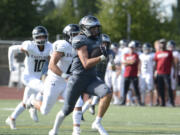 Union running back Cody Zehner races past Eastlake defenders en route to an 81-yard touchdown run in the first quarter Saturday.