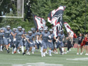 Union players run on to the field prior to the start of Saturday’s season-opening game against Eastlake at McKenzie Stadium in Vancouver (Will Denner/The Columbian)