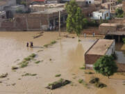 Residents wade through a flood hit area following heavy monsoon rains in Charsadda district of Khyber Pakhtunkhwa on Aug. 29, 2022. The death toll from monsoon flooding in Pakistan since June has topped more than 1,000, according to figures released on Aug. 29, 2022, by the country's National Disaster Management Authority.