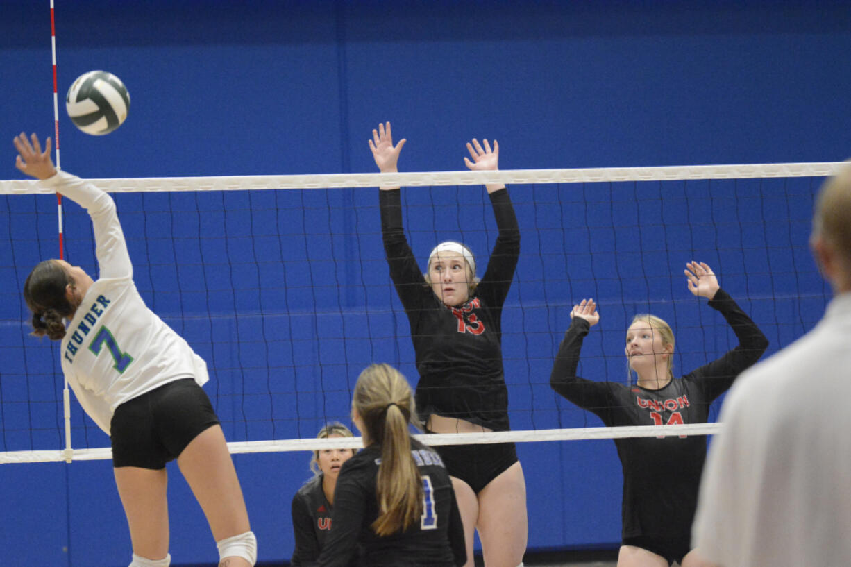 Union's Lindsay Schauer (13) and McKinley Ermshar look to make a block on a shot by Mountain View's Alexis Alvarado (7) during a match at Mountain View on Thursday, Sept. 8, 2022.