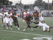 Prairie running back Alex Ford (21) avoids a Hudson's Bay defender during a 25-yard touchdown run in the first quarter of a 56-0 win on Friday, Sept. 9, 2022 at District Stadium in Battle Ground.