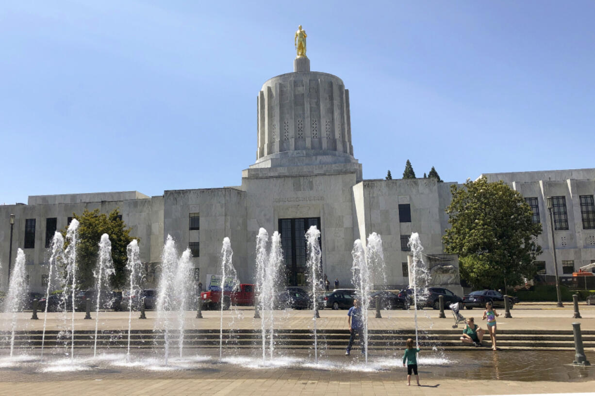 Children play in fountains June 29, 2019, at the Oregon State Capitol in Salem, Ore. Oregon likely misspent coronavirus relief funds and failed to report accurate data on some federally funded programs, state auditors said in report last week.