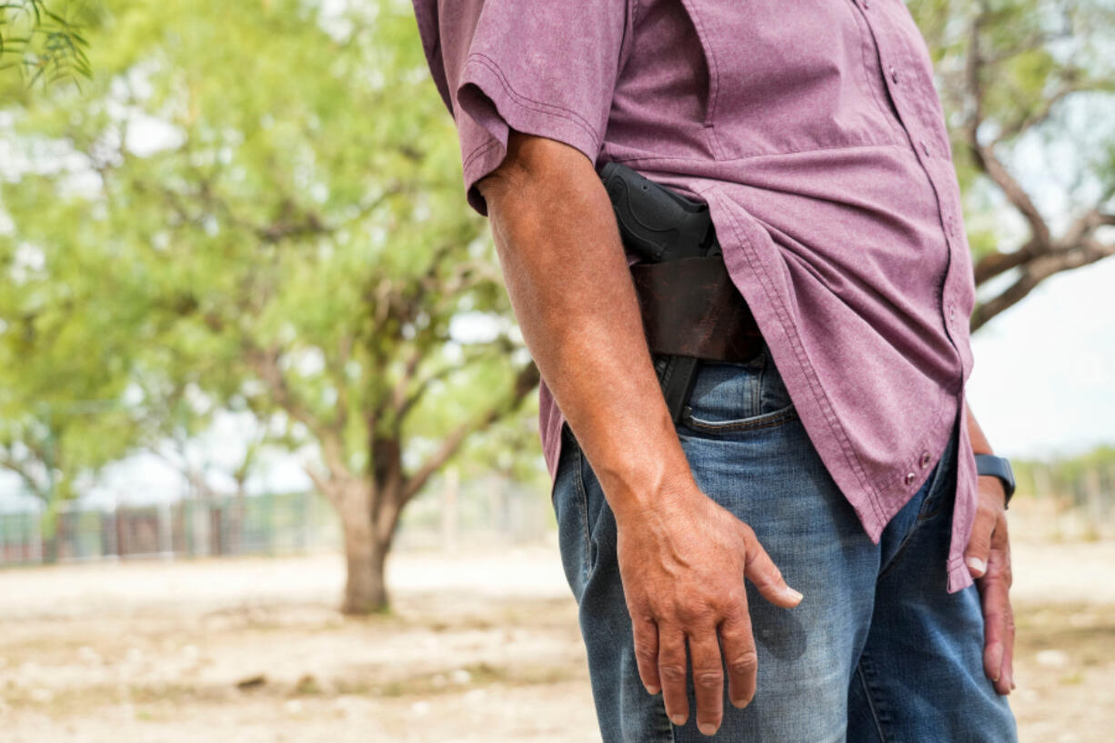 Rancher Donna Schuster carried a sidearm as she stood on her 8,000-acre ranch near Brackettville in Kinney County on Aug. 19, 2022.