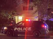 Vancouver Mayor Anne McEnerny-Ogle speaks with a Vancouver police officer Monday night outside her home in the Shumway neighborhood after an unidentified individual set a fire near the garage.