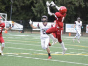 Fort Vancouver's Anton Hill leaps for an interception over Stevenson receiver Joseph Jenkins during the first quarter of a Trico League game on Friday, Sept.