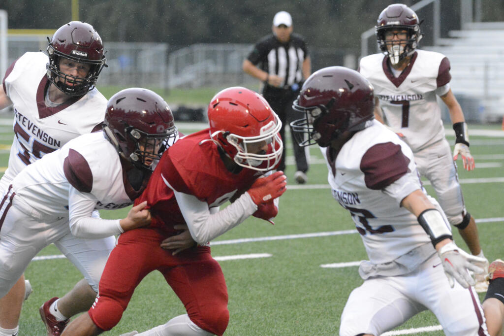 Fort Vancouver receiver Evan Mendez gains extra yardage as he's tackled by Stevenson defenders during the first quarter of a Trico League game on Friday, Sept. 16, 2022 at Kiggins Bowl.