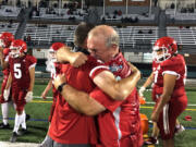 Fort Vancouver coach Doug Bilodeau hugs an assistant coach after a 29-27 win over Stevenson on Friday.