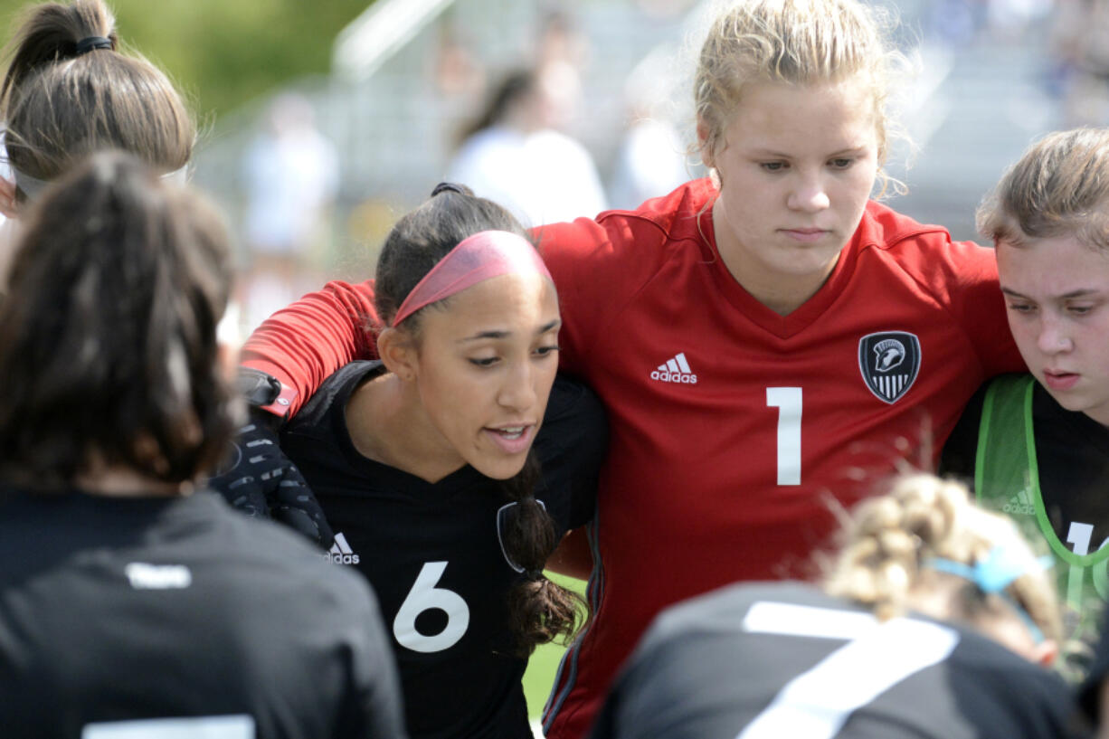 Prior to the start of the second half against Glacier Peak, Union captain Maya Woods (6) talks to her teammates in a huddle on Saturday, Sept. 17, 2022, at Union High School.