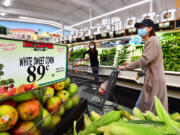 People grocery shop April 21 in Rosemead, Calif. Unprocessed, whole foods are things like fresh fruits and vegetables, rice, meat and eggs. (Frederic J.