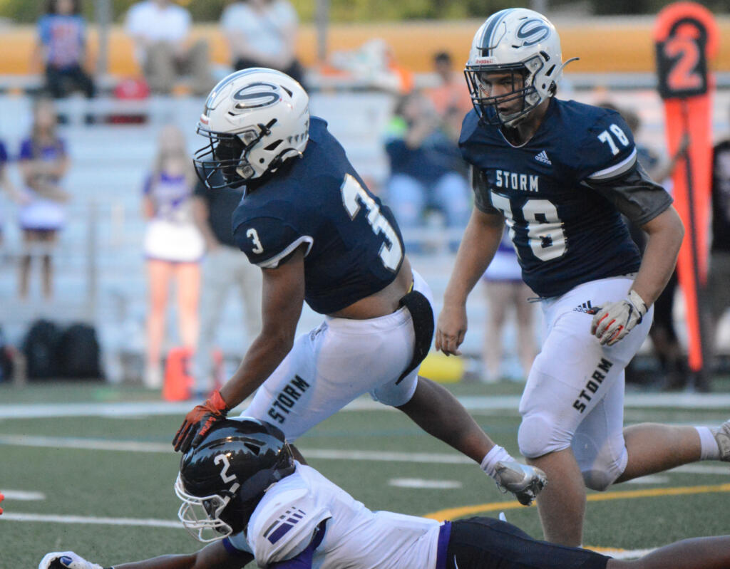 Skyview running back Trey Jacob looks to break a tackle against Kamiak defender Ben'tre Worthy on Friday at Kiggins Bowl in Vancouver.