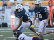 Skyview running back Trey Jacob looks to break a tackle against Kamiak defender Ben'tre Worthy on Friday at Kiggins Bowl in Vancouver.