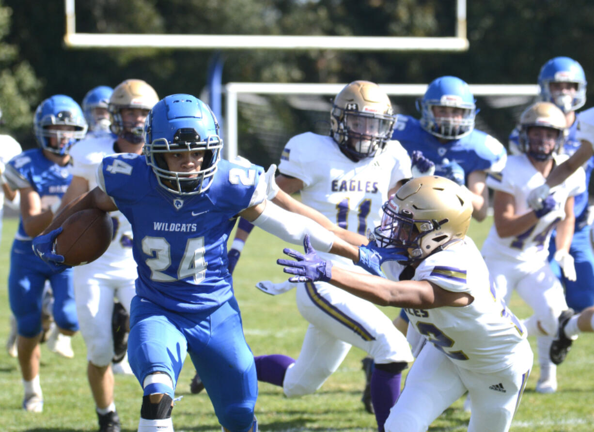 La Center's Davari Grauer stiff arms a Connell player on the second-half kickoff on Saturday in La Center. Grauer returned the kickoff for a touchdown to put the Wildcats ahead 42-0.