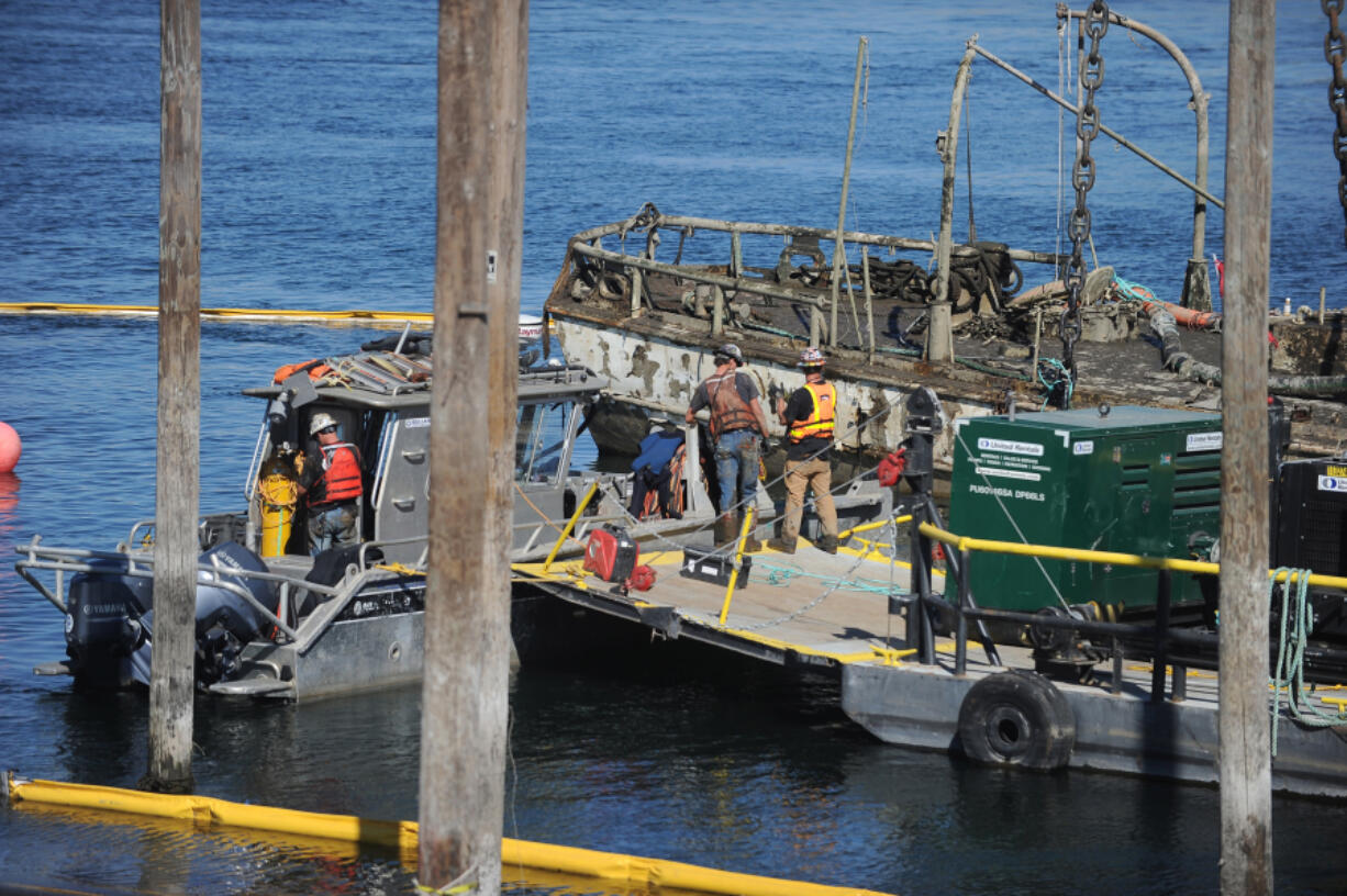 Shari Phiel/The Columbian
The U.S. Coast Guard has begun efforts to lift the Alert from the Columbia River, where it sunk in November. After crews spent Saturday pumping water from the vessel, most of the ship could now be seen above the water line. (shari phiel/The Columbian)