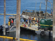 Shari Phiel/The Columbian
The U.S. Coast Guard has begun efforts to lift the Alert from the Columbia River, where it sunk in November. After crews spent Saturday pumping water from the vessel, most of the ship could now be seen above the water line. (shari phiel/The Columbian)