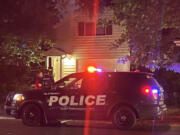 Vancouver Mayor Anne McEnerny-Ogle speaks with a Vancouver police officer Monday night outside her home in the Shumway neighborhood after an unidentified individual set a fire near the garage.