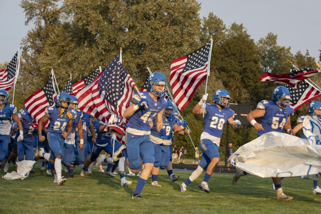 The La Center varsity football team makes an entrance before a game against Hockinson at La Center High School, Friday, Sept. 2, 2022.