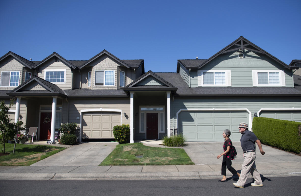 Laura and Dick Gill of Vancouver stroll through their neighborhood on their way to catch a bus on a recent morning. They say walking to the bus stop invigorates them.