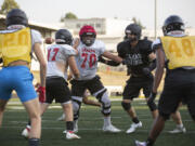 Camas' Carson Osmus, center, participates in team drills at football practice Wednesday at Camas High School.