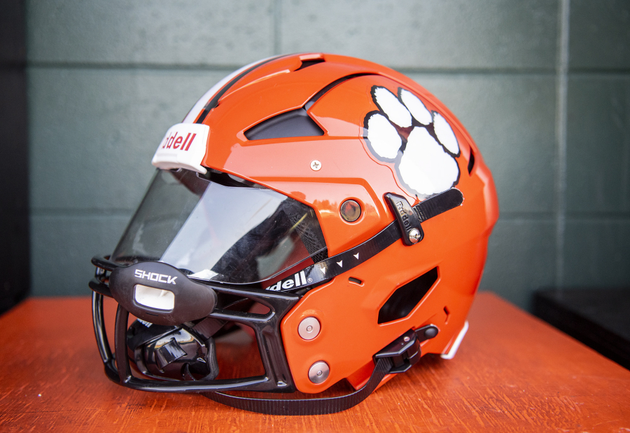 A new Battle Ground helmet sits on a wooden box Tuesday, Sept. 20, 2022, at Battle Ground High School. Ex-NFL player Michael Roos purchased custom-made Axiom helmets for a number of Tigers to wear. The helmets are designed for each player's specific head and include impact sensing and other technology for better safety.