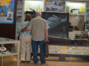 Chlovena Byrd and Owen Ratliff, friends for 30 years, look at exhibits before the "Fourth Plain Forward: Building Community" presentation began.