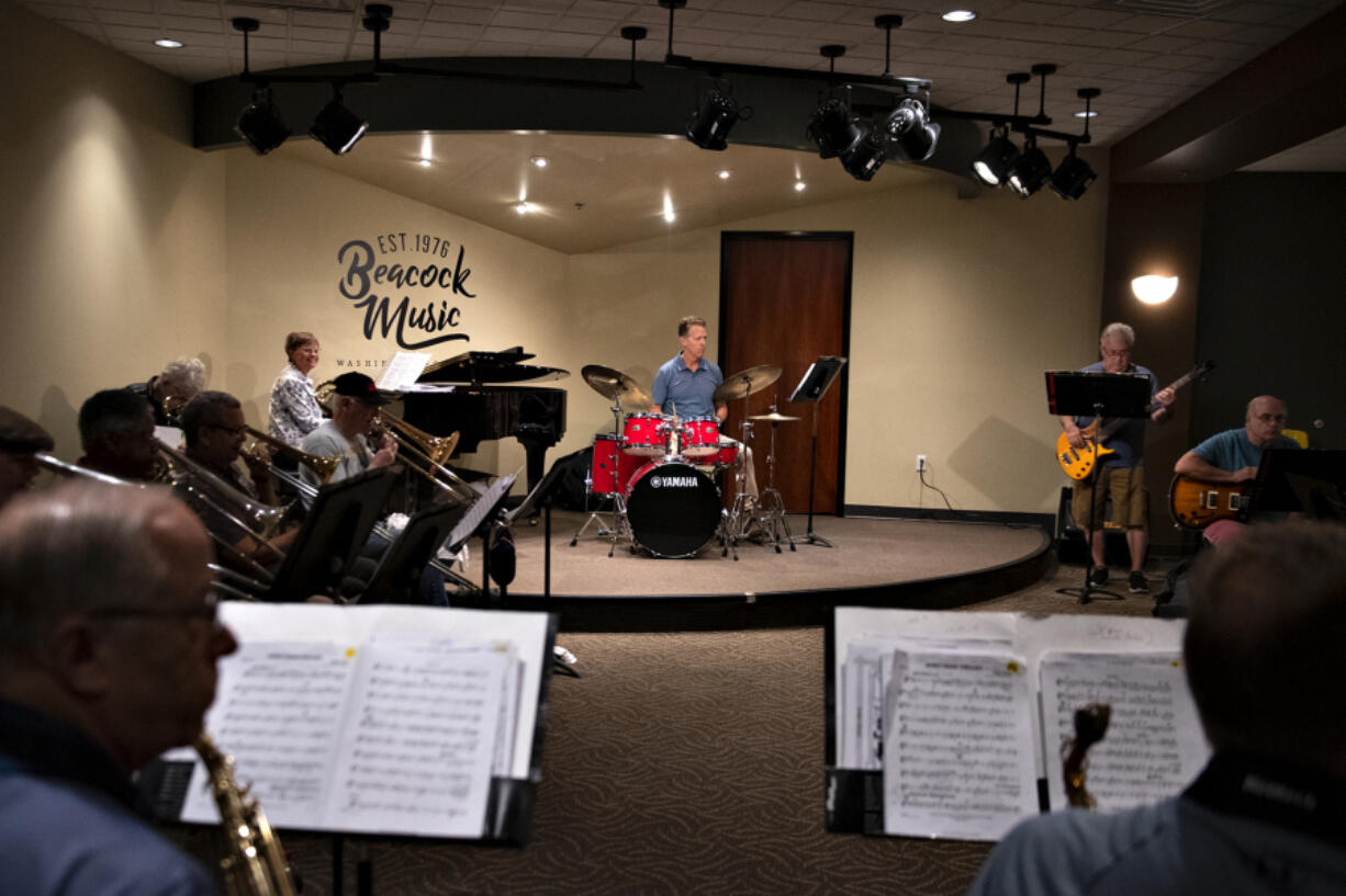 Russ Beacock, center, co-owner of Beacock Music, takes a seat behind the drum kit while playing with the Beacock Community Big Band. The Vancouver store is an institution and has been growing in recent years. It's expanding its territory farther with a new shop in Albany, Ore., set to open Nov. 1.