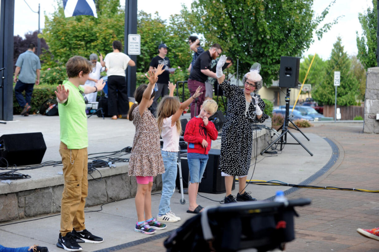 The Ridgefield Multicultural Festival in downtown Ridgefield on Saturday showcases a diverse array of performances from around the world. Cheryl Willis, known professionally as Miriam Stairwellsky, of Rose City Clowns, performs with volunteers at the festival.