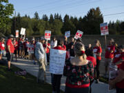 Joe Thayer, center in gray sweatshirt and hat, joins union members as they gather to strike after a deal has not been reached between the teachers union and school officials despite working without a contract since Sep. 1, as seen in Ridgefield on Friday morning, Sept. 9, 2022.