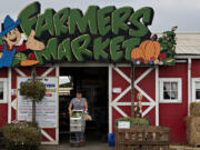 Shopper Lyubov Igumnov of Vancouver leaves Bi-Zi Farms with a cart full of fresh produce on Monday afternoon. The farm is gearing up to celebrate its 150th anniversary with an event on Sunday.