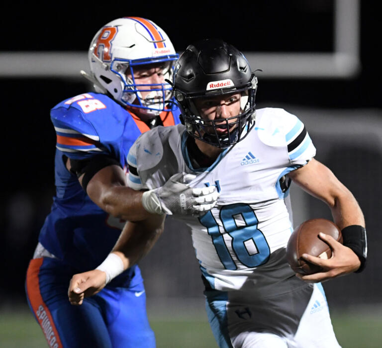 Ridgefield senior Wyatt Bartroff, left, tackles Hockinson senior quarterback Jared Oldham on Friday, Sept. 16, 2022, during Ridgefield’s 26-21 win against Hockinson at Ridgefield High School.