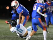 Ridgefield senior Isaiah Cowley (1) runs over Hockinson sophomore Zachary Chung on Friday, Sept. 16, 2022, during Ridgefield’s 26-21 win against Hockinson at Ridgefield High School.