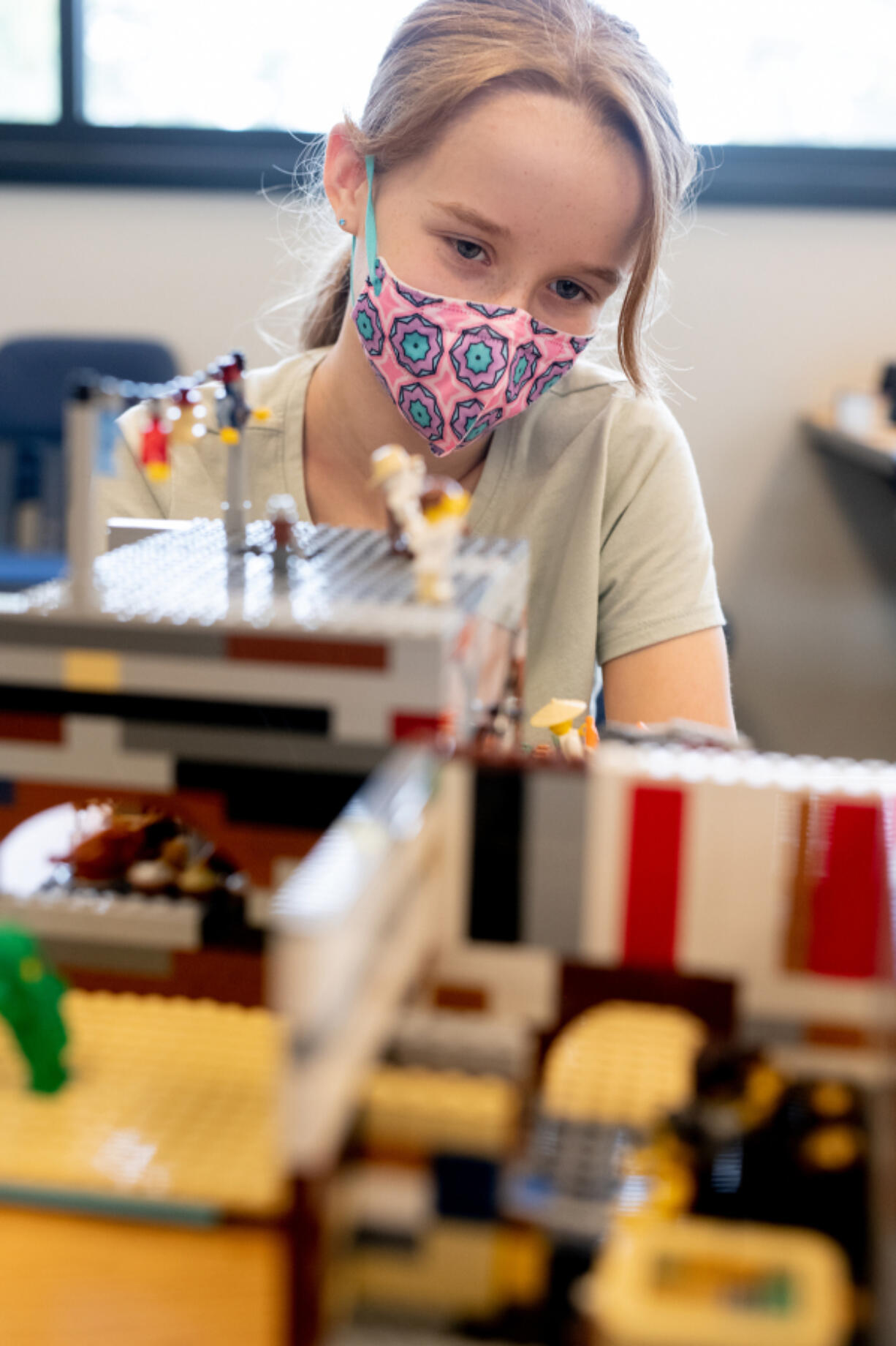 Elise Robertson, 11, of Camas looks over her Wild West-themed Lego build during the Columbia Play Project's inaugural Bricktastic Competition and Showcase on Saturday at Clark College in Vancouver. Her submission earned her the Best in Show prize.