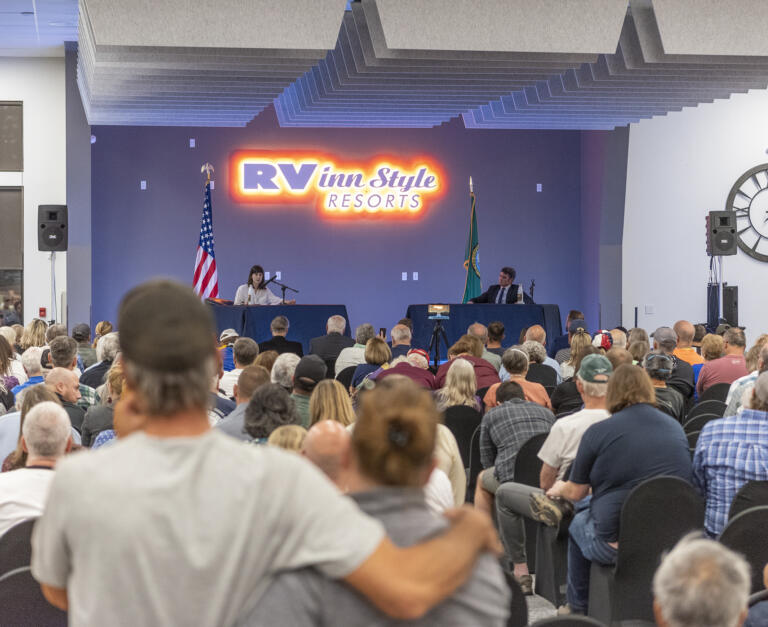 *BEST WIDE* People listen to Washington House District 3 candidates Joe Kent, right, and Marie Gluesenkamp Perez speak at a debate Tuesday, Sept. 27, 2022, at RV Inn Style Resorts Convention Center.