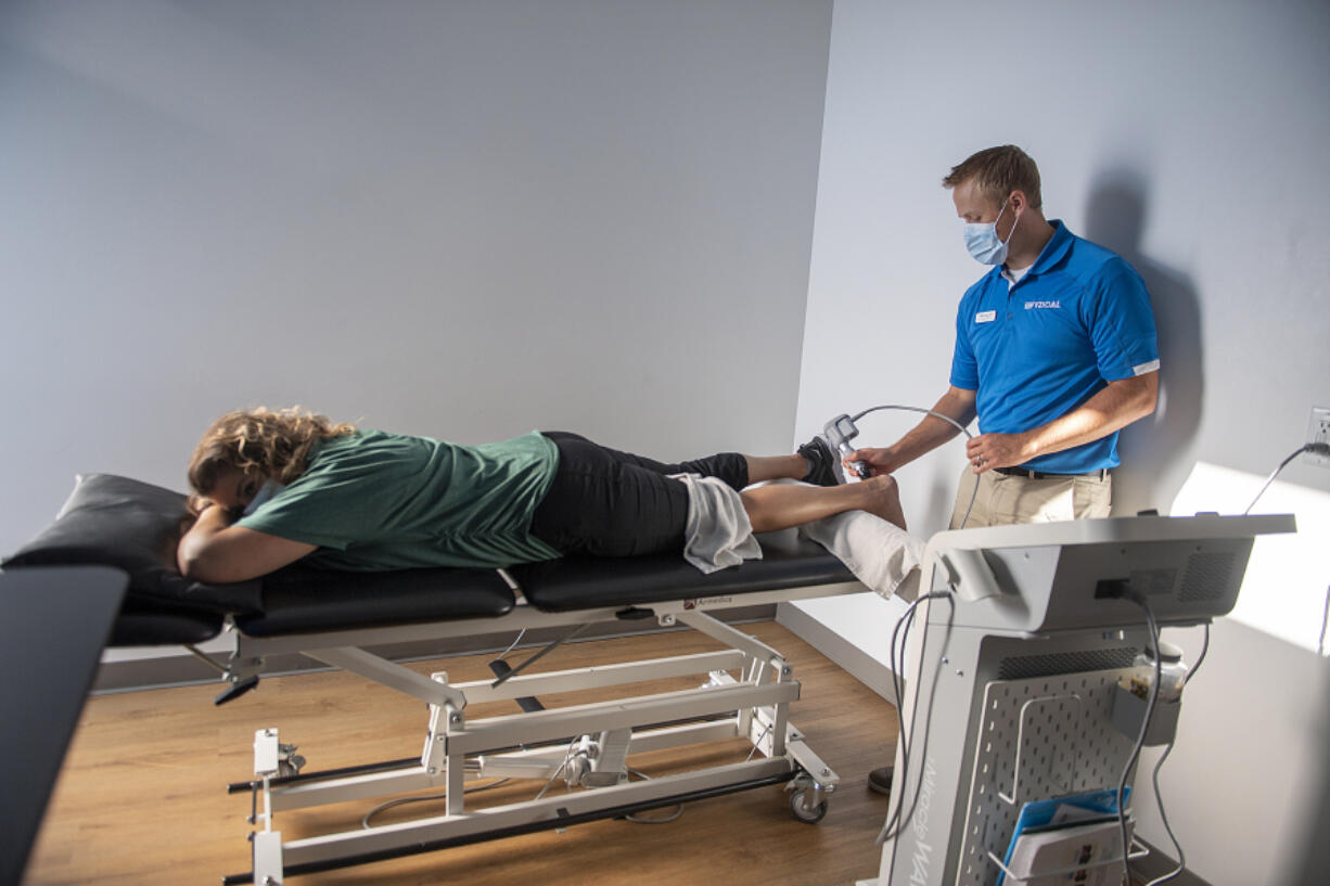 Ridgefield resident Anna Presley, left, gets treatment for a soccer injury from physical therapist Mike Teater at FYZICAL Therapy & Balance Center of Camas.