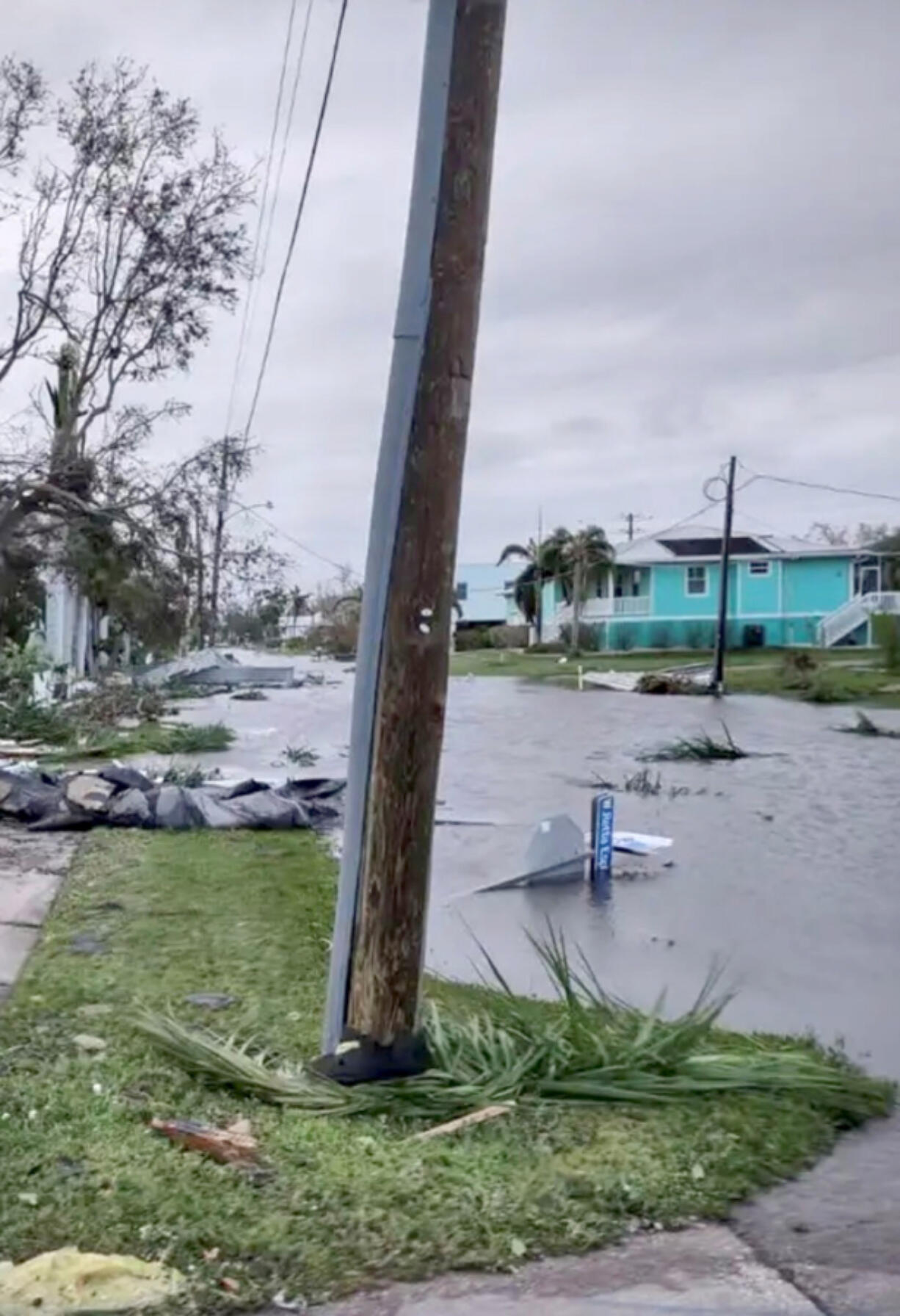 One of Lou Brancaccio's neighbors shared photos showing Lou's aqua-colored house after Hurricane Ian passed through Punta Gorda, Fla. on Thursday. The dark patch on his roof is a solar water heater for his pool.