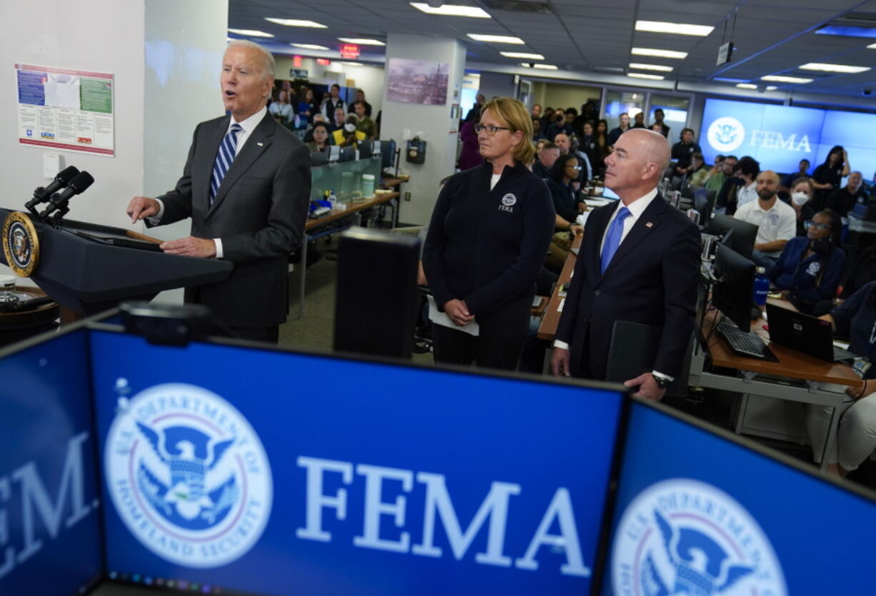 President Joe Biden speaks about Hurricane Ian during a visit to FEMA headquarters, Thursday, Sept. 29, 2022, in Washington. FEMA Administrator Deanne Criswell and Homeland Security Secretary Alejandro Mayorkas look on.