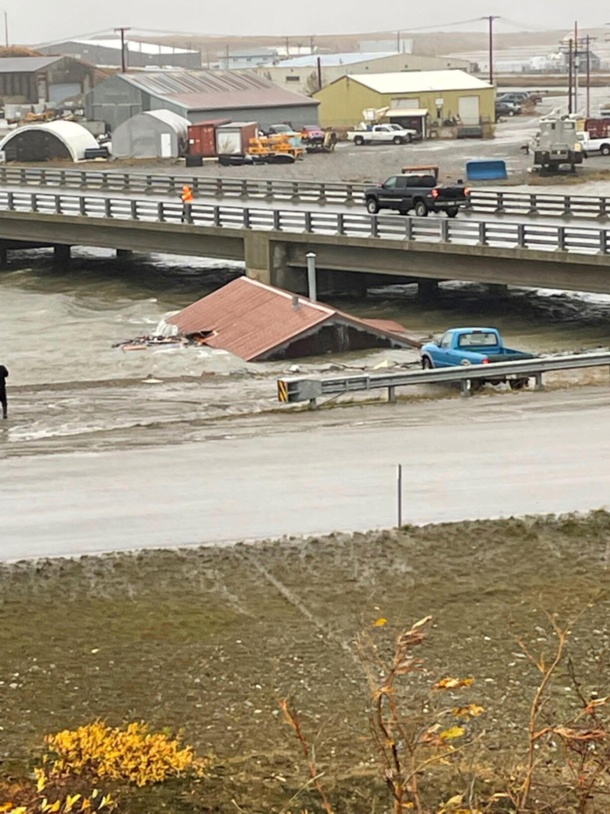 A home that was knocked off its foundation and floated down Snake River during a severe storm in Nome, Alaska, is caught under a bridge Saturday, Sept. 17, 2022. Much of Alaska's western coast was battered by the storm, which was the remnant of Typhoon Merbok, causing the most damage of any storm in the last half century.