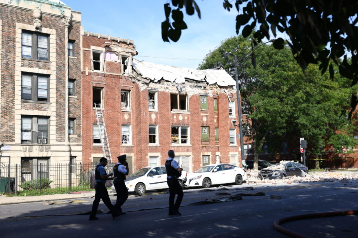 Fire crews respond to the scene of an explosion inside a building on Tuesday, Sept. 20, 2022, in Chicago.  Several people were rushed to hospitals after being injured when an explosion on Tuesday morning tore through the top floor of an apartment building on Chicago's West Side and the fire department was requesting help to search the building, officials said.