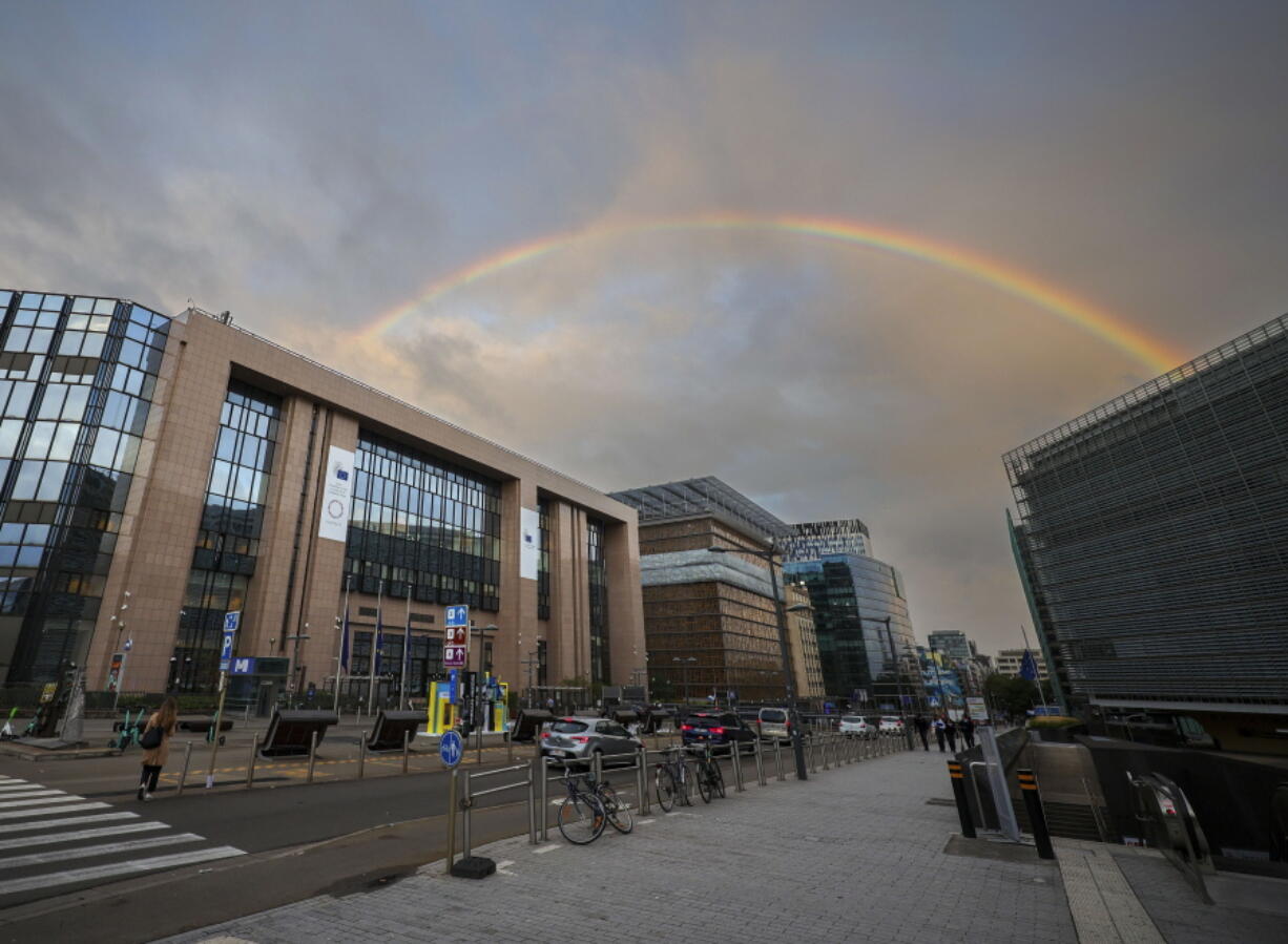 A rainbow forms between the European Council building, left, and the European Commission building right outside a meeting of EU energy ministers in Brussels, Friday, Sept. 9, 2022. European Union energy ministers are holding an emergency meeting Friday to discuss the bloc's electricity market.