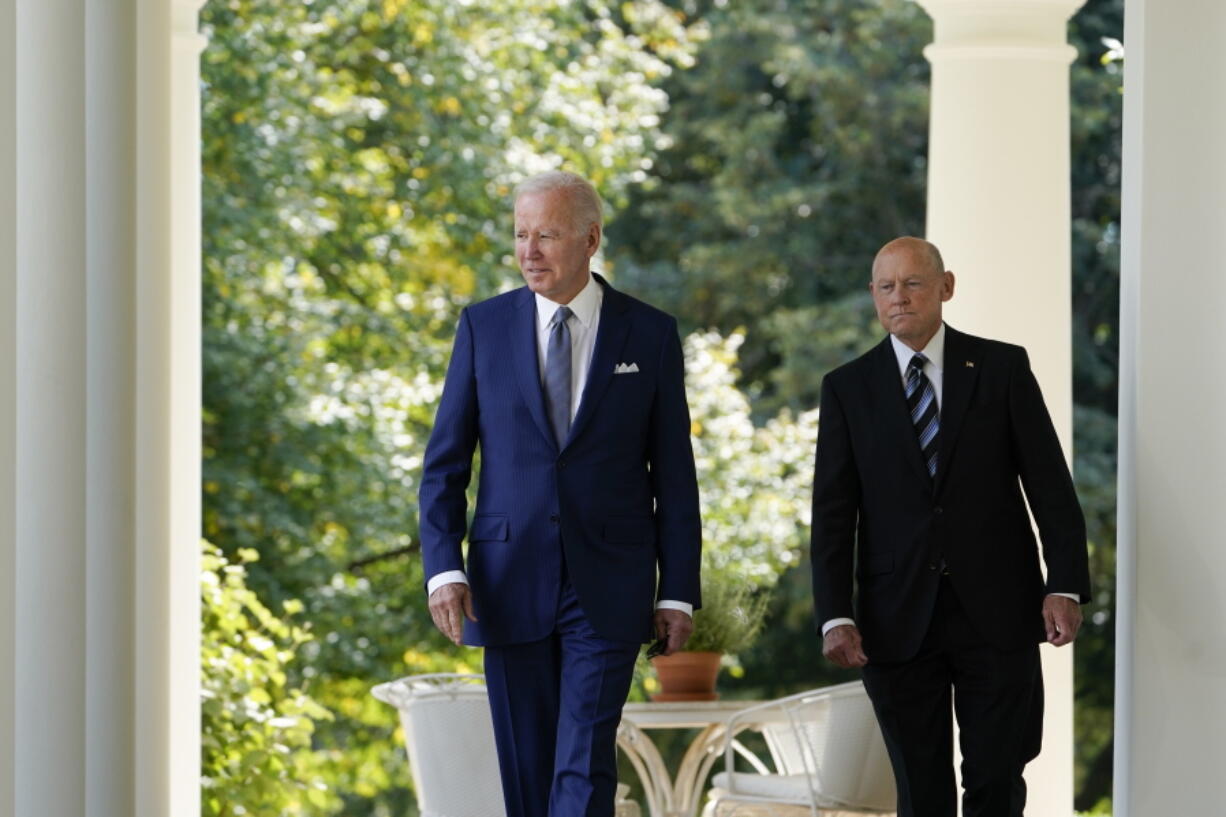 President Joe Biden walks with Bob Parant, Medicare beneficiary with Type 1 diabetes, as they arrive to speak at an event on health care costs, in the Rose Garden of the White House, Tuesday, Sept. 27, 2022, in Washington.