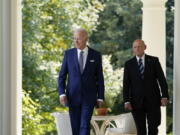 President Joe Biden walks with Bob Parant, Medicare beneficiary with Type 1 diabetes, as they arrive to speak at an event on health care costs, in the Rose Garden of the White House, Tuesday, Sept. 27, 2022, in Washington.