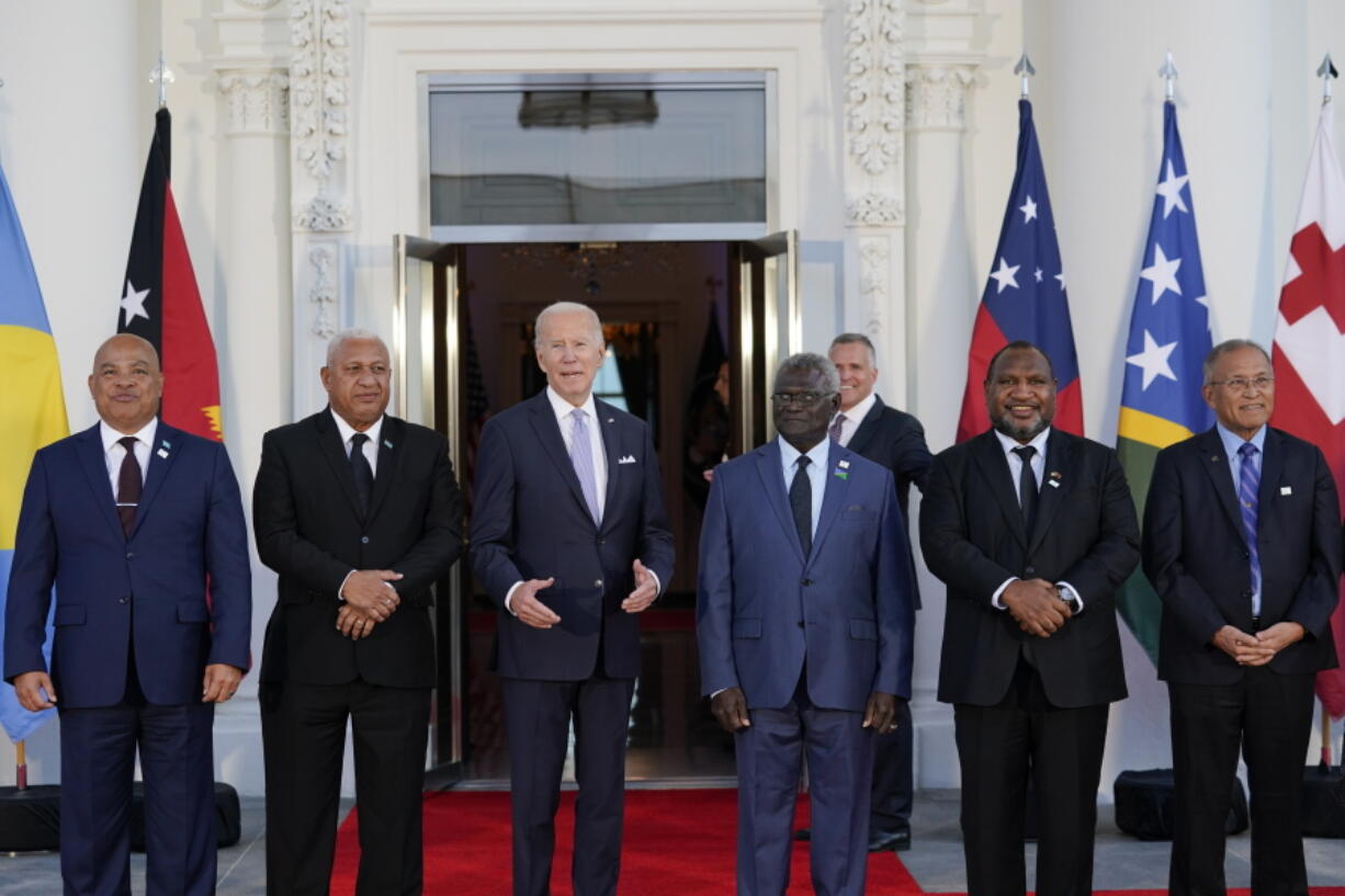 President Joe Biden, third from left, speaks as he poses for photos with Pacific Island leaders on the North Portico of the White House in Washington, Thursday, Sept. 29, 2022. From left, Micronesia President David Panuelo, Fiji Prime Minister Josaia Voreqe Bainimarama, Biden, Solomon Islands Prime Minister Manasseh Sogavare, Papua New Guinea Prime Minister James Marape, and Marshall Islands President David Kabua.