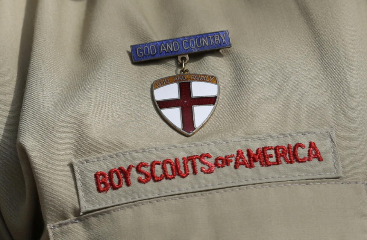 FILE - A close up of a Boy Scout uniform is photographed on Feb. 4, 2013, in Irving, Texas. A Delaware bankruptcy judge has approved a $2.46 billion reorganization plan Thursday, Sept. 8, 2022, proposed by the Boy Scouts of America that would allow it to continue operating while compensating tens of thousands of men who say were sexually abused as children while involved in Scouting.