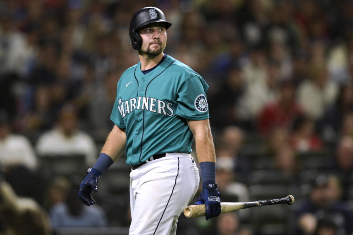 Seattle Mariners' Cal Raleigh returns to the dugout after striking out against the Atlanta Braves during the ninth inning of a baseball game Friday, Sept. 9, 2022, in Seattle.