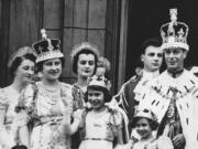 FILE - Princess Elizabeth, centre, age 11, appears on the balcony of Buckingham Palace after the coronation of her father, King George VI, right, in London, May 12, 1937. Queen Elizabeth II, Britain's longest-reigning monarch and a rock of stability across much of a turbulent century, has died. She was 96. Buckingham Palace made the announcement in a statement on Thursday Sept. 8, 2022.