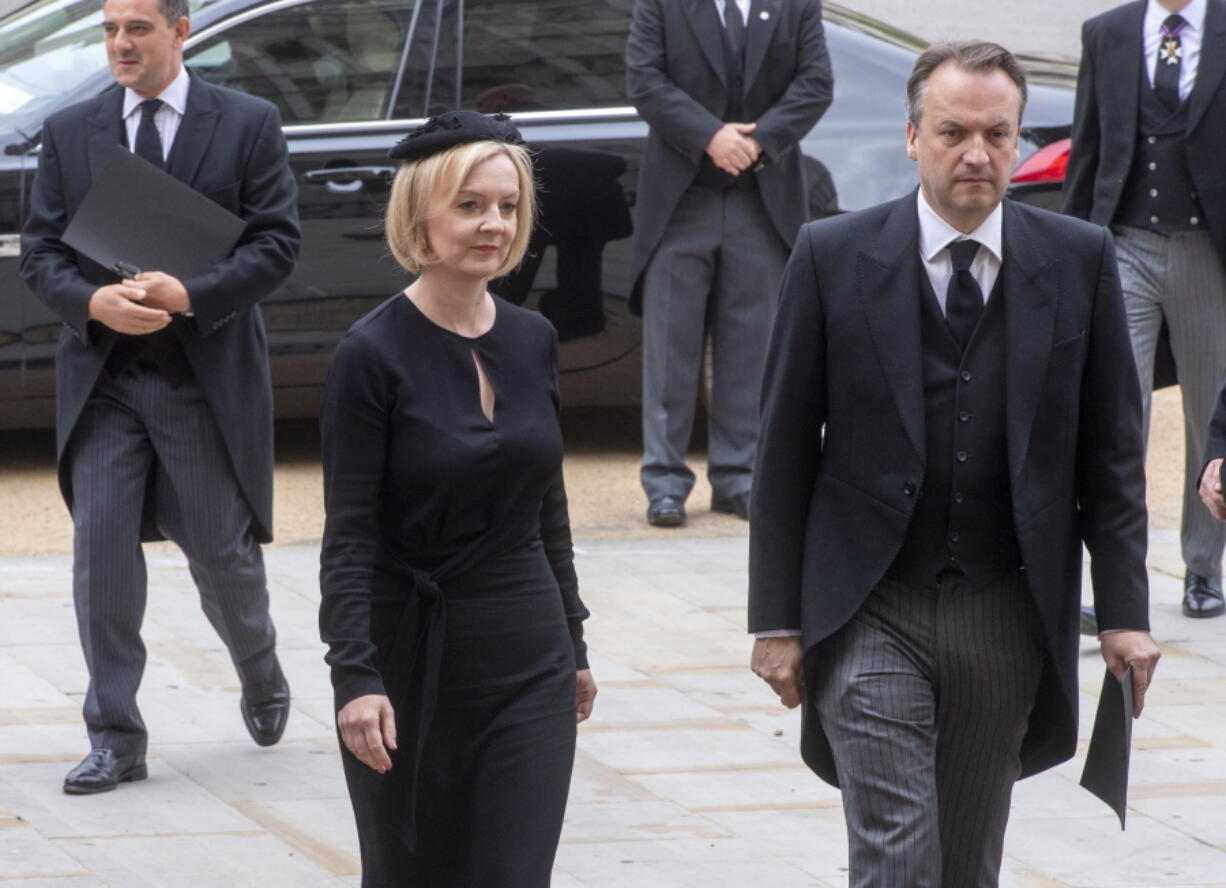 British Prime Minister Liz Truss and her husband Hugh O'Leary arrive for the funeral service of Queen Elizabeth II at Westminster Abbey in central London, Monday Sept. 19, 2022. The Queen, who died aged 96 on Sept. 8, will be buried at Windsor alongside her late husband, Prince Philip, who died last year.