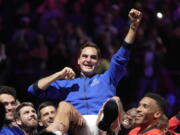 Roger Federer is lifted in celebration by fellow players Friday at the Laver Cup in London after playing the final match of his illustrious tennis career.