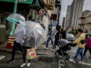 Rain drenches streets in Chinatown in San Francisco, on Sunday, Sept. 18, 2022. The rainstorm is a dramatic shift of events for many residents after a record heat wave and grueling wildfire season. (Bront?