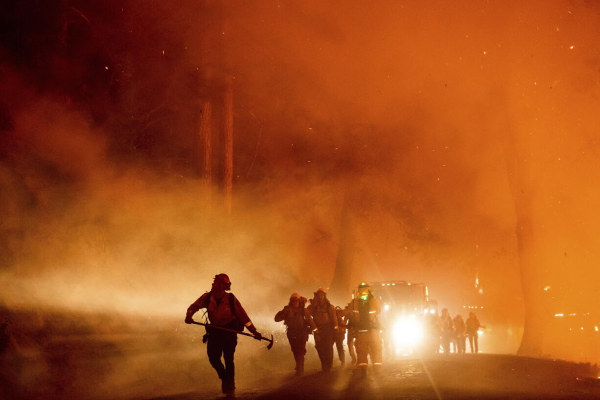 Firefighters battle the Mosquito Fire burning on Michigan Bluff Rd. in unincorporated Placer County, Calif., on Wednesday, Sept. 7, 2022.